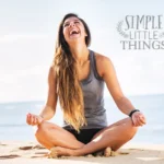 woman on a beach laughing yoga